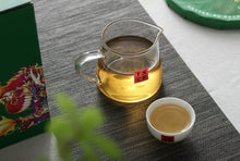 Load image into Gallery viewer, 2017 XiaGuan "Dong Fang Zhi Zhu - Bu Lang Gu Shu" (Oriental Pearl - Bulang Old Tree) Iron Cake 357g Puerh Sheng Cha Raw Tea