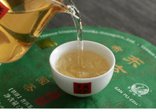 Load image into Gallery viewer, 2017 XiaGuan "Dong Fang Zhi Zhu - Bu Lang Gu Shu" (Oriental Pearl - Bulang Old Tree) Iron Cake 357g Puerh Sheng Cha Raw Tea