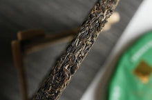 Load image into Gallery viewer, 2017 XiaGuan "Dong Fang Zhi Zhu - Bu Lang Gu Shu" (Oriental Pearl - Bulang Old Tree) Iron Cake 357g Puerh Sheng Cha Raw Tea