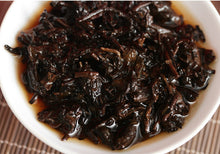 Load image into Gallery viewer, 2017 XiaGuan "Dong Fang Zhi Zhu - Bu Lang Gu Shu" (Oriental Pearl - Bulang Old Tree) Iron Cake 357g Puerh Shou Cha Ripe Tea