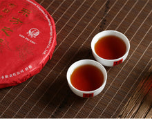 Load image into Gallery viewer, 2017 XiaGuan "Dong Fang Zhi Zhu - Bu Lang Gu Shu" (Oriental Pearl - Bulang Old Tree) Iron Cake 357g Puerh Shou Cha Ripe Tea