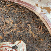 Load image into Gallery viewer, 2005 XingHai "Yin Kong Que - Gu Shu Qiao Mu" (Silvers Peacock - Menghai Old Arbor Tree) 501 Batch Cake 357g Puerh Ripe Tea Shou Cha