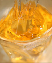 Load image into Gallery viewer, Clear glass cup with yellow liquid and text describing the tea&#39;s color and aroma.