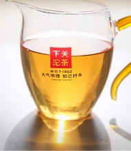 Load image into Gallery viewer, Glass teapot with tea and brand logo on a white background