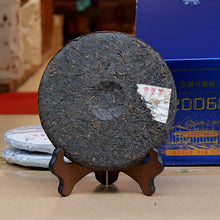 Load image into Gallery viewer, 500g Cake Dark Tea · Wuzhou, Guangxi**

Name: Liu Bao Tea – Pressed Cake “20060”
Brand: Sanhe (Three Cranes / Wuzhou Tea Factory)
Grade: Special Grade (Te Ji)
Form: Pressed Tea Cake
Specification: 500g per cake · 6 cakes per bundle · 24 cakes per carton
Aroma Profile: Betel-nut aroma · Fungal/“Golden Flower” floral aroma
Aging Start Date: December 25, 2020
Production Date: January 8, 2024

⸻

Product Description

The 20060 Liu Bao tea cake is produced by Wuzhou Tea Factory using carefully selected 2020 spri