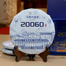 Load image into Gallery viewer, 500g Cake Dark Tea · Wuzhou, Guangxi**

Name: Liu Bao Tea – Pressed Cake “20060”
Brand: Sanhe (Three Cranes / Wuzhou Tea Factory)
Grade: Special Grade (Te Ji)
Form: Pressed Tea Cake
Specification: 500g per cake · 6 cakes per bundle · 24 cakes per carton
Aroma Profile: Betel-nut aroma · Fungal/“Golden Flower” floral aroma
Aging Start Date: December 25, 2020
Production Date: January 8, 2024

⸻

Product Description

The 20060 Liu Bao tea cake is produced by Wuzhou Tea Factory using carefully selected 2020 spri