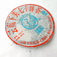 Load image into Gallery viewer, Wrapped Chinese puerh tea cake with red and blue label on white background