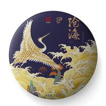 Load image into Gallery viewer, Chinese tea cake with a crane, ocean waves, and calligraphy on dark round packaging