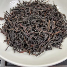 Load image into Gallery viewer, From the mist-shrouded peaks of Wu Dong Mountain, the historic heart of Phoenix Single Bush in Chaozhou, Guangdong, comes one of the most sought-after DanCong lots of the 2024 spring harvest: “Dong Fang Hong” – Eastern Red.

Grown at 1,100–1,250 m altitude on ancient, wild-arbor tea trees (some exceeding 100 years), this S+ grade selection is hand-picked in mid-April from the celebrated “MiLan Xiang” (Honey-Orchid Fragrance) cultivar lineage. Only the finest one-bud-two-leaf sets are chosen, ensuring extrao
