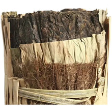 Load image into Gallery viewer, Close-up of traditional Chinese puerh tea brick wrapped in natural bamboo leaf packaging