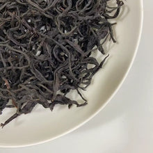 Load image into Gallery viewer, Appearance Tightly and black, large tea threads. Dry leaves release an intense natural aroma of cinnamon, rose petals, and cool mint even before brewing.

Liquor Vivid ruby-red with jewel-like transparency and brightness.

Aroma &amp; Taste Profile

Signature “Taiwan Red Trilogy”: cinnamon warmth + damask rose + refreshing mint coolness
Pronounced honey and ripe stone-fruit sweetness
Zero astringency, silky-smooth body
Powerful, long-lasting sweet aftertaste (hui gan) and a cooling sensation that reaches de
