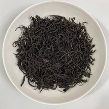 Load image into Gallery viewer, Appearance Bold, tightly twisted dark threads. Dry leaves give off an intense, natural aroma of dark cocoa, malt, ripe cherries, and a touch of molasses.

Liquor Deep, glowing reddish-copper with excellent clarity and brightness.

Aroma &amp; Taste Profile

Rich malt and cocoa body – the true hallmark of top Assam
Pronounced dark honey and sun-ripened stone fruit (plum &amp; longan)
Natural caramel-like sweetness with gentle, pleasant briskness
Full-bodied, thick mouthfeel and strong, warming cha qi
Long, s