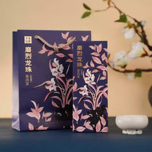 Load image into Gallery viewer, Chinese tea gift box and bag with floral design, Puerh tea packaging on blue table