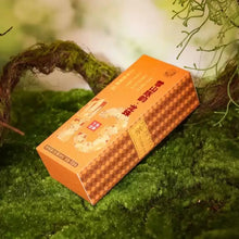 Load image into Gallery viewer, Box of Chinese puerh tea with orange packaging on green moss background