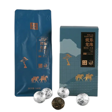 Load image into Gallery viewer, Chinese puerh tea in blue packaging with gold camel and tree designs, loose tea balls in front