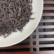 Load image into Gallery viewer, From the mist-shrouded peaks of Wu Dong Mountain, the historic heart of Phoenix Single Bush in Chaozhou, Guangdong, comes one of the most sought-after DanCong lots of the 2024 spring harvest: “Dong Fang Hong” – Eastern Red.

Grown at 1,100–1,250 m altitude on ancient, wild-arbor tea trees (some exceeding 100 years), this S+ grade selection is hand-picked in mid-April from the celebrated “MiLan Xiang” (Honey-Orchid Fragrance) cultivar lineage. Only the finest one-bud-two-leaf sets are chosen, ensuring extrao