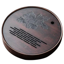 Load image into Gallery viewer, Round wooden coaster with floral design and text on a white Product Name: Round Tea Tray

Material: Bamboo + Laminate Board Base

Size:

Small : Diameter 25 * Height 5 cm

Medium: Diameter 29 * Height 5 cm

Large : Diameter 38 * Height 5 cm



This Round Tea Tray is an exquisite piece of craftsmanship, designed for the ritual of Gongfu tea, a traditional Chinese method of tea preparation that focuses on the aesthetic presentation and sharing. The tray is constructed from high-quality bamboo, a matbackground