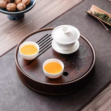 Load image into Gallery viewer, Product Name: Round Tea Tray

Material: Bamboo + Laminate Board Base

Size:

Small : Diameter 25 * Height 5 cm

Medium: Diameter 29 * Height 5 cm

Large : Diameter 38 * Height 5 cm



This Round Tea Tray is an exquisite piece of craftsmanship, designed for the ritual of Gongfu tea, a traditional Chinese method of tea preparation that focuses on the aesthetic presentation and sharing. The tray is constructed from high-quality bamboo, a material revered for its durability and natural beauty.

The surface of t