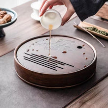 Load image into Gallery viewer, Product Name: Round Tea Tray

Material: Bamboo + Laminate Board Base

Size:

Small : Diameter 25 * Height 5 cm

Medium: Diameter 29 * Height 5 cm

Large : Diameter 38 * Height 5 cm



This Round Tea Tray is an exquisite piece of craftsmanship, designed for the ritual of Gongfu tea, a traditional Chinese method of tea preparation that focuses on the aesthetic presentation and sharing. The tray is constructed from high-quality bamboo, a material revered for its durability and natural beauty.

The surface of t