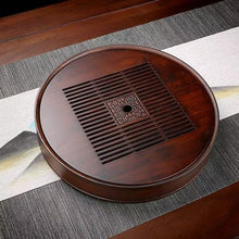Load image into Gallery viewer, Product Name: Round Tea Tray

Material: Bamboo + Laminate Board Base

Size:

Small : Diameter 25 * Height 5 cm

Medium: Diameter 29 * Height 5 cm

Large : Diameter 38 * Height 5 cm



This Round Tea Tray is an exquisite piece of craftsmanship, designed for the ritual of Gongfu tea, a traditional Chinese method of tea preparation that focuses on the aesthetic presentation and sharing. The tray is constructed from high-quality bamboo, a material revered for its durability and natural beauty.

The surface of t