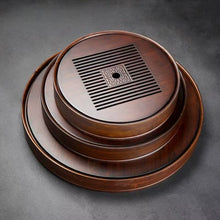 Load image into Gallery viewer, Product Name: Round Tea Tray

Material: Bamboo + Laminate Board Base

Size:

Small : Diameter 25 * Height 5 cm

Medium: Diameter 29 * Height 5 cm

Large : Diameter 38 * Height 5 cm



This Round Tea Tray is an exquisite piece of craftsmanship, designed for the ritual of Gongfu tea, a traditional Chinese method of tea preparation that focuses on the aesthetic presentation and sharing. The tray is constructed from high-quality bamboo, a material revered for its durability and natural beauty.

The surface of t
