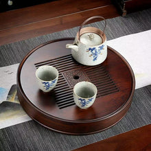 Load image into Gallery viewer, Product Name: Round Tea Tray

Material: Bamboo + Laminate Board Base

Size:

Small : Diameter 25 * Height 5 cm

Medium: Diameter 29 * Height 5 cm

Large : Diameter 38 * Height 5 cm



This Round Tea Tray is an exquisite piece of craftsmanship, designed for the ritual of Gongfu tea, a traditional Chinese method of tea preparation that focuses on the aesthetic presentation and sharing. The tray is constructed from high-quality bamboo, a material revered for its durability and natural beauty.

The surface of t