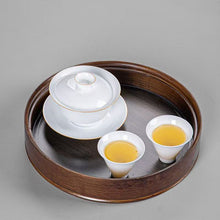Load image into Gallery viewer, Product Name: Round Tea Tray

Material: Bamboo + Laminate Board Base

Size:

Small : Diameter 25 * Height 5 cm

Medium: Diameter 29 * Height 5 cm

Large : Diameter 38 * Height 5 cm



This Round Tea Tray is an exquisite piece of craftsmanship, designed for the ritual of Gongfu tea, a traditional Chinese method of tea preparation that focuses on the aesthetic presentation and sharing. The tray is constructed from high-quality bamboo, a material revered for its durability and natural beauty.

The surface of t