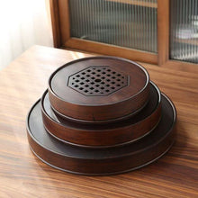 Load image into Gallery viewer, Product Name: Round Tea Tray

Material: Bamboo + Laminate Board Base

Size:

Small : Diameter 25 * Height 5 cm

Medium: Diameter 29 * Height 5 cm

Large : Diameter 38 * Height 5 cm



This Round Tea Tray is an exquisite piece of craftsmanship, designed for the ritual of Gongfu tea, a traditional Chinese method of tea preparation that focuses on the aesthetic presentation and sharing. The tray is constructed from high-quality bamboo, a material revered for its durability and natural beauty.

The surface of t