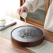 Load image into Gallery viewer, Product Name: Round Tea Tray

Material: Bamboo + Laminate Board Base

Size:

Small : Diameter 25 * Height 5 cm

Medium: Diameter 29 * Height 5 cm

Large : Diameter 38 * Height 5 cm



This Round Tea Tray is an exquisite piece of craftsmanship, designed for the ritual of Gongfu tea, a traditional Chinese method of tea preparation that focuses on the aesthetic presentation and sharing. The tray is constructed from high-quality bamboo, a material revered for its durability and natural beauty.

The surface of t