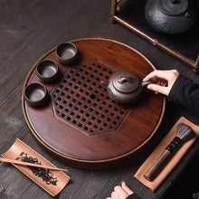 Load image into Gallery viewer, Product Name: Round Tea Tray

Material: Bamboo + Laminate Board Base

Size:

Small : Diameter 25 * Height 5 cm

Medium: Diameter 29 * Height 5 cm

Large : Diameter 38 * Height 5 cm



This Round Tea Tray is an exquisite piece of craftsmanship, designed for the ritual of Gongfu tea, a traditional Chinese method of tea preparation that focuses on the aesthetic presentation and sharing. The tray is constructed from high-quality bamboo, a material revered for its durability and natural beauty.

The surface of t