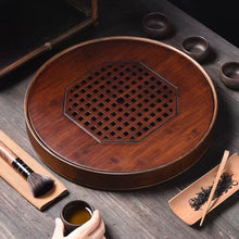 Load image into Gallery viewer, Product Name: Round Tea Tray

Material: Bamboo + Laminate Board Base

Size:

Small : Diameter 25 * Height 5 cm

Medium: Diameter 29 * Height 5 cm

Large : Diameter 38 * Height 5 cm



This Round Tea Tray is an exquisite piece of craftsmanship, designed for the ritual of Gongfu tea, a traditional Chinese method of tea preparation that focuses on the aesthetic presentation and sharing. The tray is constructed from high-quality bamboo, a material revered for its durability and natural beauty.

The surface of t