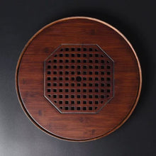 Load image into Gallery viewer, Product Name: Round Tea Tray

Material: Bamboo + Laminate Board Base

Size:

Small : Diameter 25 * Height 5 cm

Medium: Diameter 29 * Height 5 cm

Large : Diameter 38 * Height 5 cm



This Round Tea Tray is an exquisite piece of craftsmanship, designed for the ritual of Gongfu tea, a traditional Chinese method of tea preparation that focuses on the aesthetic presentation and sharing. The tray is constructed from high-quality bamboo, a material revered for its durability and natural beauty.

The surface of t
