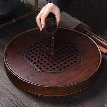 Load image into Gallery viewer, Product Name: Round Tea Tray

Material: Bamboo + Laminate Board Base

Size:

Small : Diameter 25 * Height 5 cm

Medium: Diameter 29 * Height 5 cm

Large : Diameter 38 * Height 5 cm



This Round Tea Tray is an exquisite piece of craftsmanship, designed for the ritual of Gongfu tea, a traditional Chinese method of tea preparation that focuses on the aesthetic presentation and sharing. The tray is constructed from high-quality bamboo, a material revered for its durability and natural beauty.

The surface of t