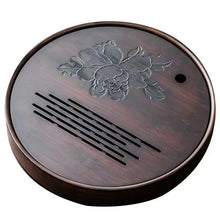 Load image into Gallery viewer, Round wooden coaster with floral design and text on a white Product Name: Round Tea Tray

Material: Bamboo + Laminate Board Base

Size:

Small : Diameter 25 * Height 5 cm

Medium: Diameter 29 * Height 5 cm

Large : Diameter 38 * Height 5 cm



This Round Tea Tray is an exquisite piece of craftsmanship, designed for the ritual of Gongfu tea, a traditional Chinese method of tea preparation that focuses on the aesthetic presentation and sharing. The tray is constructed from high-quality bamboo, a matbackground