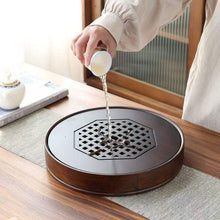Load image into Gallery viewer, Product Name: Round Tea Tray

Material: Bamboo + Laminate Board Base

Size:

Small : Diameter 25 * Height 5 cm

Medium: Diameter 29 * Height 5 cm

Large : Diameter 38 * Height 5 cm



This Round Tea Tray is an exquisite piece of craftsmanship, designed for the ritual of Gongfu tea, a traditional Chinese method of tea preparation that focuses on the aesthetic presentation and sharing. The tray is constructed from high-quality bamboo, a material revered for its durability and natural beauty.

The surface of t