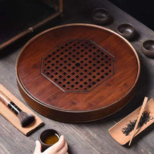 Load image into Gallery viewer, Product Name: Round Tea Tray

Material: Bamboo + Laminate Board Base

Size:

Small : Diameter 25 * Height 5 cm

Medium: Diameter 29 * Height 5 cm

Large : Diameter 38 * Height 5 cm



This Round Tea Tray is an exquisite piece of craftsmanship, designed for the ritual of Gongfu tea, a traditional Chinese method of tea preparation that focuses on the aesthetic presentation and sharing. The tray is constructed from high-quality bamboo, a material revered for its durability and natural beauty.

The surface of t