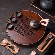 Load image into Gallery viewer, Product Name: Round Tea Tray

Material: Bamboo + Laminate Board Base

Size:

Small : Diameter 25 * Height 5 cm

Medium: Diameter 29 * Height 5 cm

Large : Diameter 38 * Height 5 cm



This Round Tea Tray is an exquisite piece of craftsmanship, designed for the ritual of Gongfu tea, a traditional Chinese method of tea preparation that focuses on the aesthetic presentation and sharing. The tray is constructed from high-quality bamboo, a material revered for its durability and natural beauty.

The surface of t
