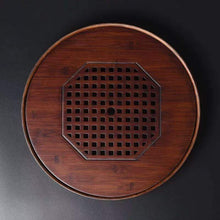 Load image into Gallery viewer, Product Name: Round Tea Tray

Material: Bamboo + Laminate Board Base

Size:

Small : Diameter 25 * Height 5 cm

Medium: Diameter 29 * Height 5 cm

Large : Diameter 38 * Height 5 cm



This Round Tea Tray is an exquisite piece of craftsmanship, designed for the ritual of Gongfu tea, a traditional Chinese method of tea preparation that focuses on the aesthetic presentation and sharing. The tray is constructed from high-quality bamboo, a material revered for its durability and natural beauty.

The surface of t