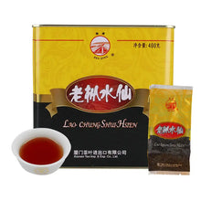 Load image into Gallery viewer, Lao Chung Shui Hsien Chinese oolong tea tin, individual packet, and brewed tea in a white cup