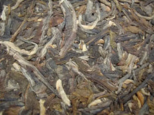 Load image into Gallery viewer, Loose leaf raw puerh tea with twisted, multi-colored dry leaves