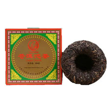 Load image into Gallery viewer, Chinese puerh tea cake with red and green box, loose tea leaves formed in a round shape