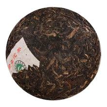 Carica l'immagine nel visualizzatore di Gallery, Compressed puerh tea ball with visible tea leaves and partial paper wrapper