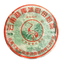 Carica l'immagine nel visualizzatore di Gallery, Compressed Chinese puerh tea cake with crane design and red-green Chinese text on wrapper