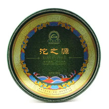 Load image into Gallery viewer, Yunnan Chinese puerh tea cake in decorative round green and gold tin, labeled since 1902.
