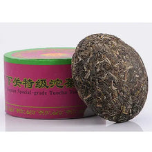 Charger l'image dans la galerie, Compressed Chinese puerh tea cake with green and pink packaging, labeled Tuocha tea