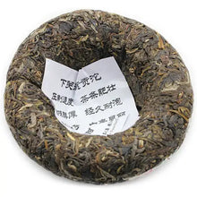Load image into Gallery viewer, Chinese pu-erh tea cake nest shape with visible tea leaves and paper insert