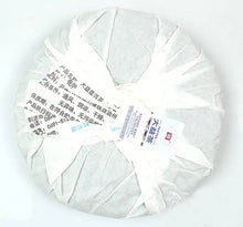 Load image into Gallery viewer, Wrapped Chinese puerh tea cake with Mandarin label on white background