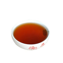 Load image into Gallery viewer, Ceramic teacup filled with dark Chinese tea on white background