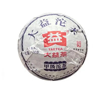 Load image into Gallery viewer, Wrapped Chinese Pu-erh tea cake with Taetea label, featuring Chinese characters on packaging.