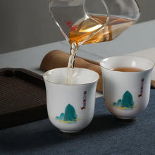 Load image into Gallery viewer, Chinese tea being poured into porcelain teacups with landscape designs, Gongfu tea set